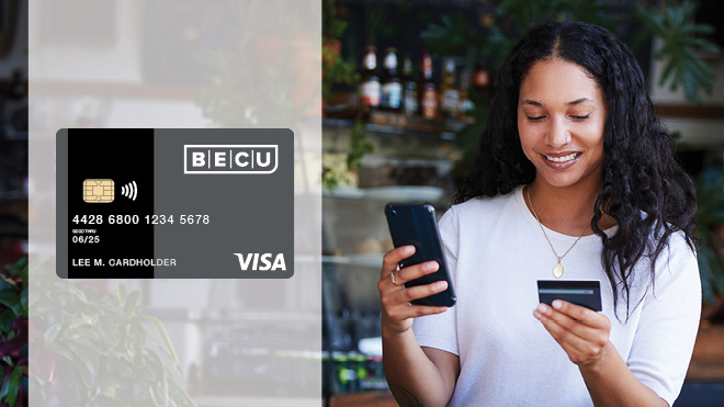 a woman holding a credit card and a phone