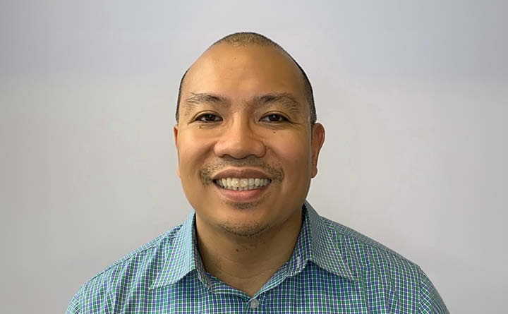 A headshot of BECU employee MJ V. He is wearing a blue collared shirt.