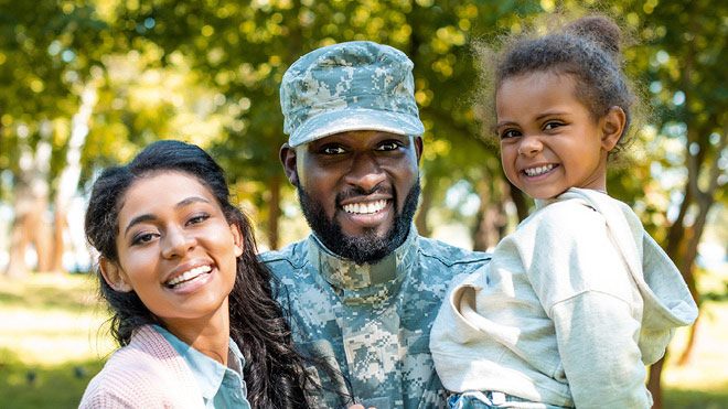 a man in military uniform with two children