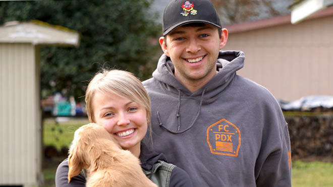 Smiling couple with puppy