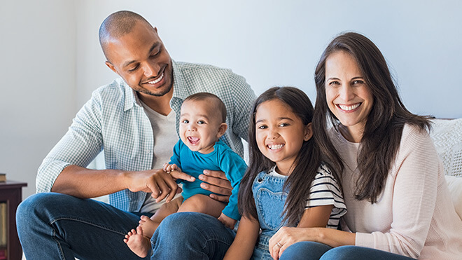a family sitting on a couch