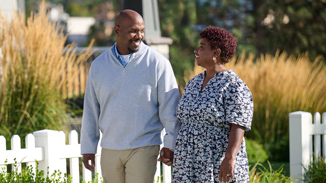 A couple walking outdoors and holding hands