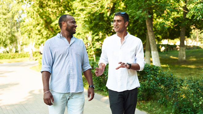 Two men walking together at a park