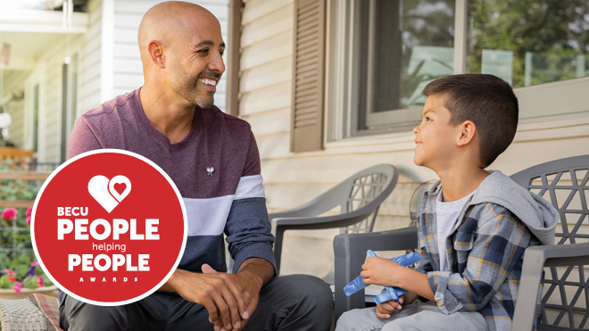 Smiling father and young sitting outside on a porch