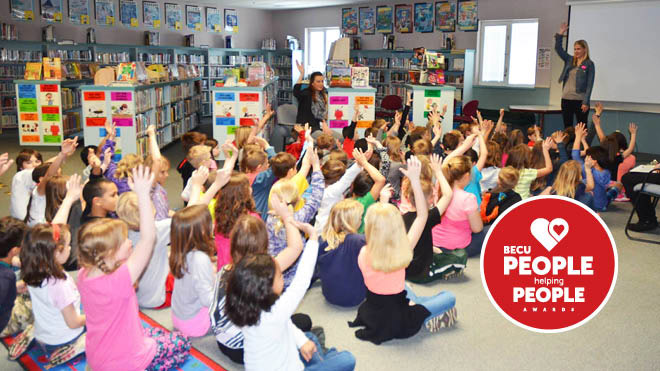 Children in a classroom raising their hands, People Helping People logo
