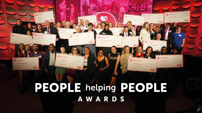 People Helping People Award Winners - a group of people holding award checks