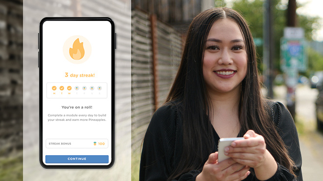 Woman with long brown hair is smiling and holding a mobile phone