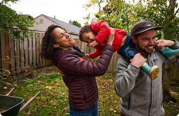 a man and woman holding a baby