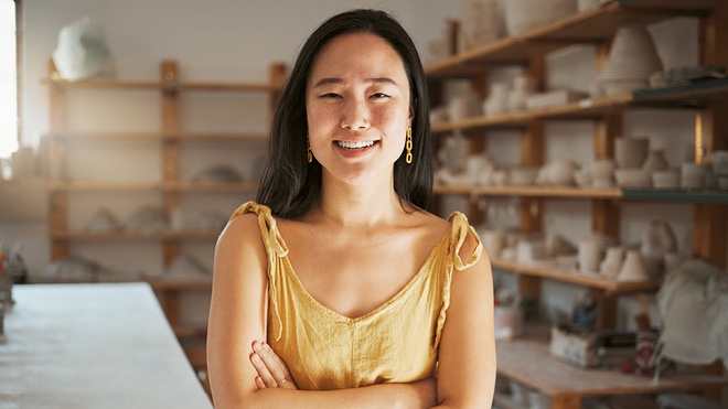 Smiling women in pottery shop.