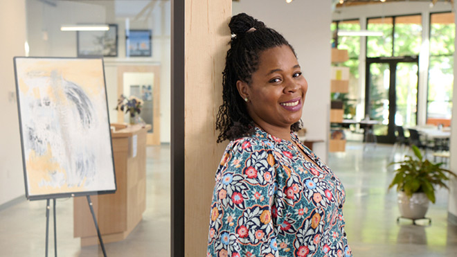 a woman leaning against a wall