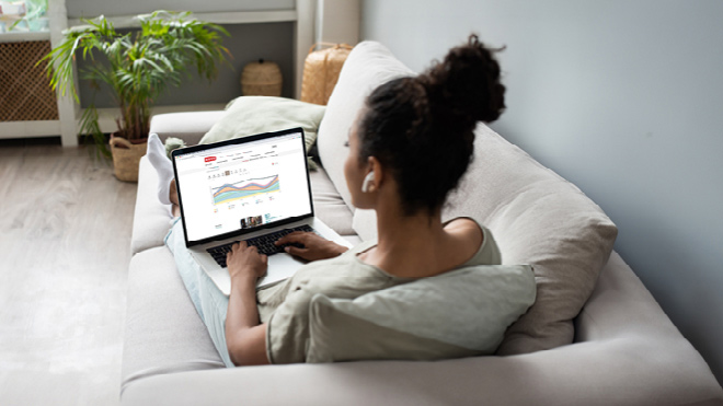 A woman reviewing her finances on BECU Money Manager on her laptop.