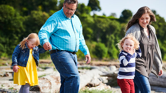 a man and woman walking with children