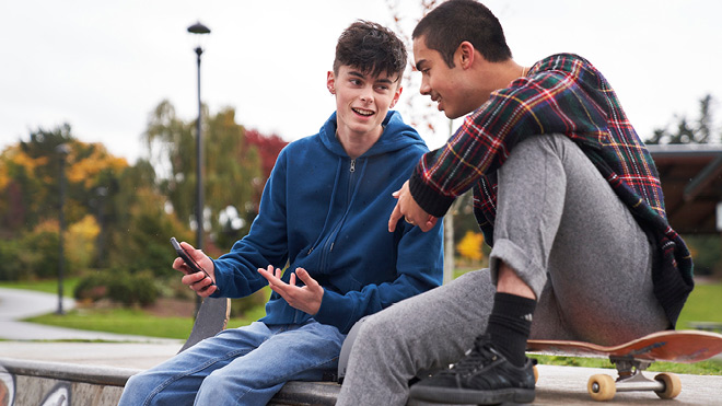 a group of young men sitting on a bench