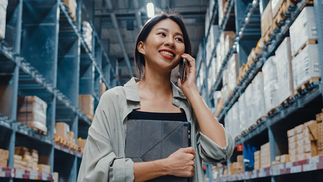Girl holding phone in a warehouse