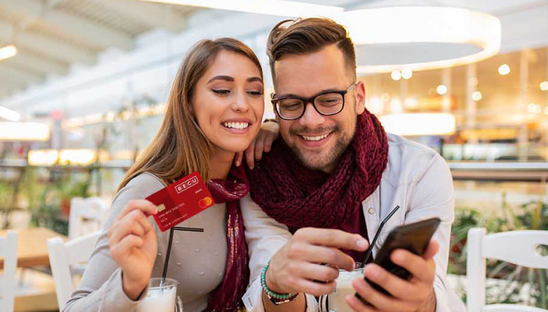 Man and woman with BECU card looking at a phone