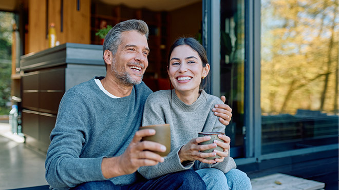 Couple sitting outside together enjoying coffee