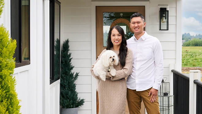 A couple and their dog on their front porch.