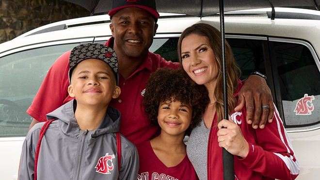 Smiling family wearing Washington State University apparel
