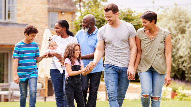 a group of people walking in a yard