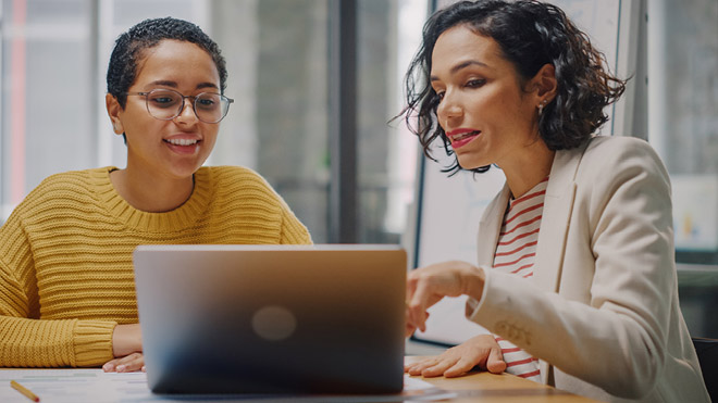 a woman looking at a laptop