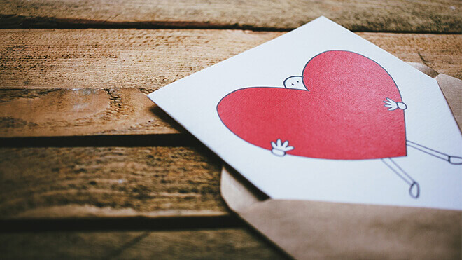 Greeting card of a cartoon person and a heart