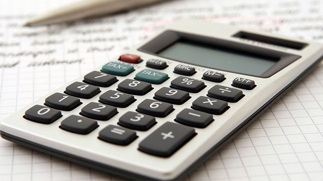 Calculator on top of tax papers