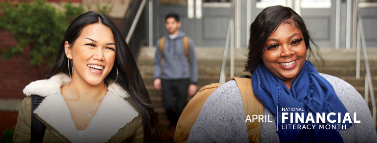Two smiling college students walk away from a building on campus together. White text in the lower right of the image reads "April: National Financial Literacy Month."