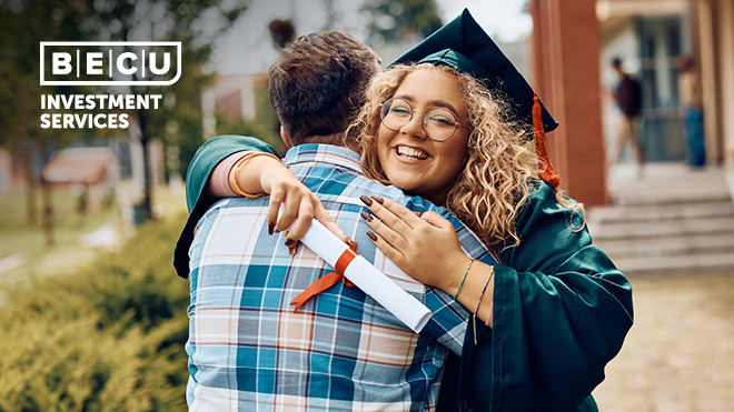 A woman wearing a graduation gown and holding her diploma hugging a man. BECU Investment Services logo.
