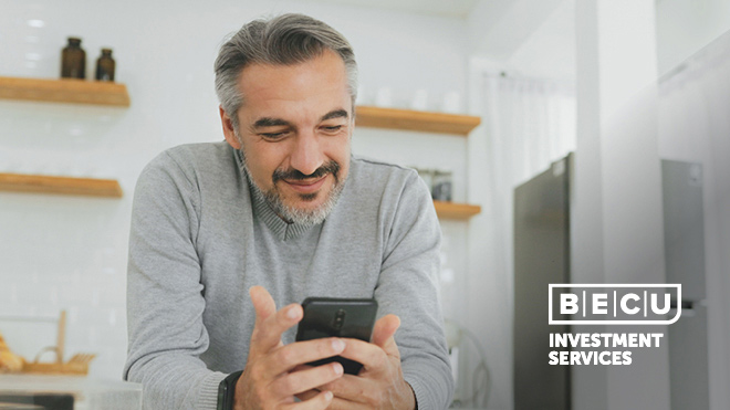 A smiling man looking at his phone. BECU Investment Services logo.