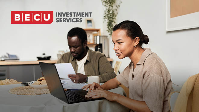 A man and woman reviewing documents and investment options on a laptop. BECU Investment Services logo.