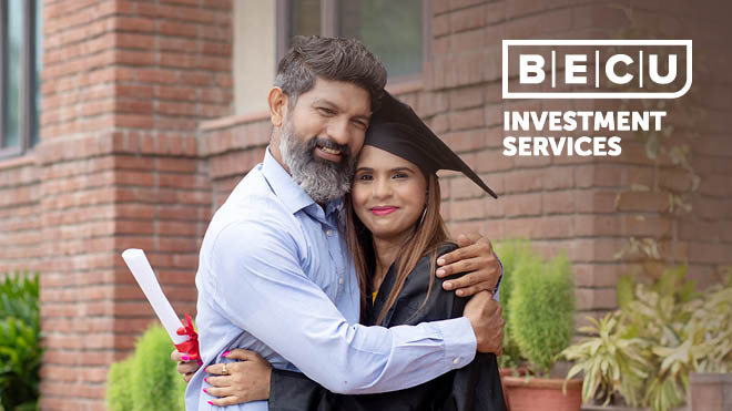 A woman in a graduation gown hugging her father while holding her diploma. BECU Investment Services.