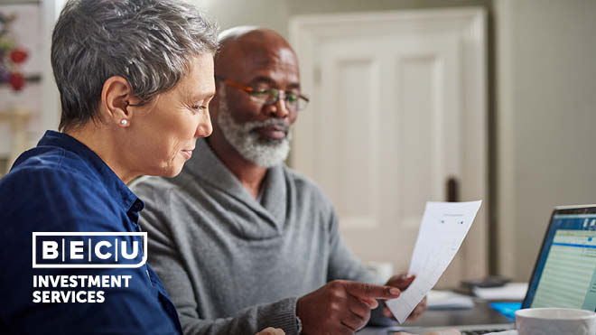 A woman and man reviewing a document.