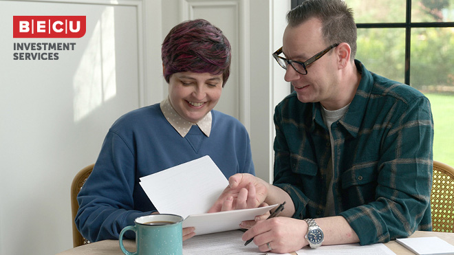 Two people reviewing tax documents. BECU Investment Services logo.