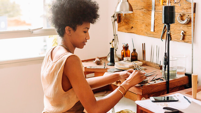 Woman using tools to craft something.
