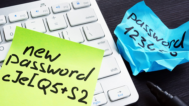 Image of laptop keyboard with password options on post-it