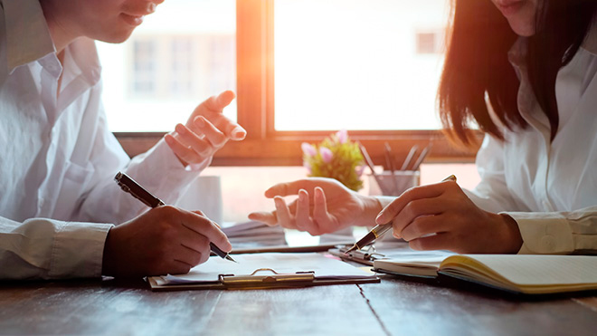 Two people doing paperwork