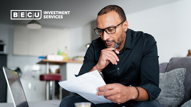 A man wearing glasses looking at a document. BECU Investment Services logo.