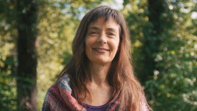 A smiling woman outdoors.