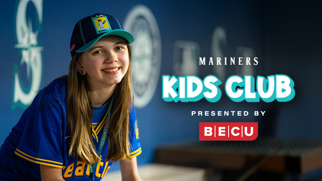 A girl wearing Seattle Mariners apparel. Mariners Kids Club Presented By BECU logo.