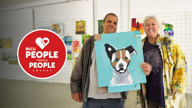 Man and woman posing with artwork