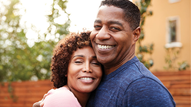 a man and a woman outside hugging each other