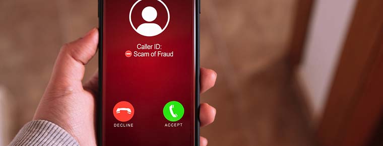 Image shows a mobile phone receiving a call that Caller ID warns might be a scam or fraud.
