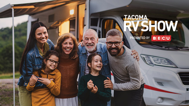 Family sitting outside by an RV