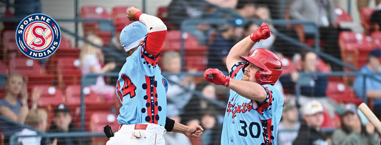Two Spokane Indian players celebrating. Spokane Indians logo.