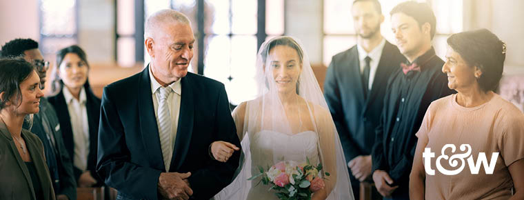 A man walking his daughter down the aisle during a wedding. Trust & Will logo.