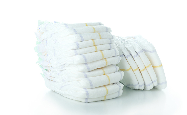 Pile of clean baby diapers stacked high, with a separate pile of clean baby diapers leaning against it, pictured on an all-white background.