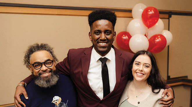 Three BECU employees from the Multicultural Emerging Leaders (MEL) Program. They are posed together in an office setting with red and white balloons behind them.
