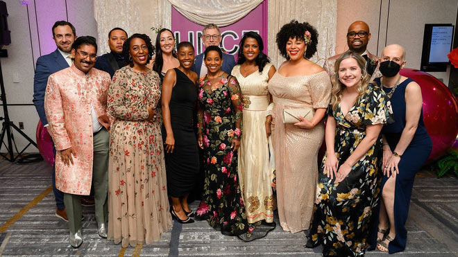 Beverly Anderson poses with BECU team members at a formal indoor event, standing in front of a branded backdrop.