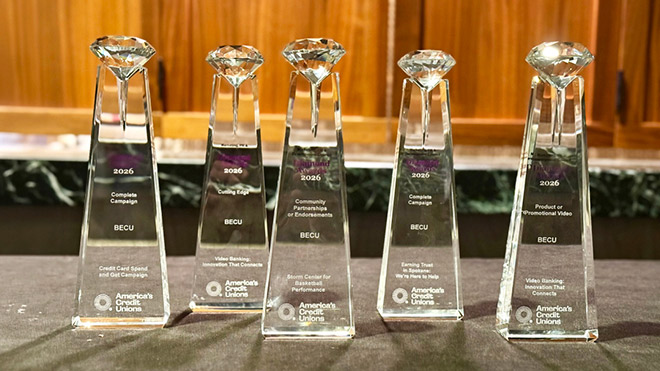Five crystal Diamond Award trophies displayed on a table, recognizing BECU campaigns honored by America’s Credit Unions.