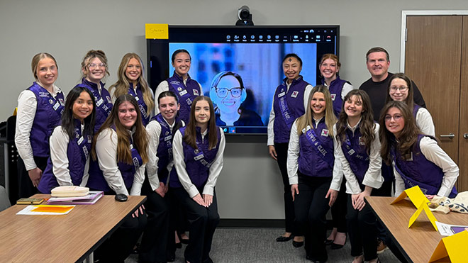 Royalty Ambassador participants pose together during a hybrid financial education session in Spokane Valley.